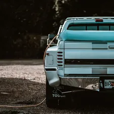 a blue pick up truck parked in a parking lot related to Choosing the Perfect Bed Cover for Your Truck: A Comprehensive Guide