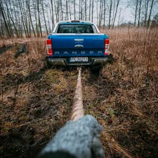 a blue truck parked in a field next to a forest related to 2004 Ford Ranger Bumper Valance