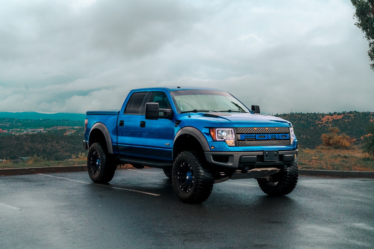a blue truck parked in a parking lot related to Upgrade Your Pickup: The Ultimate Guide to Truck Bed Side Rails