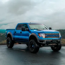 a blue truck parked in a parking lot related to Upgrade Your Pickup: The Ultimate Guide to Truck Bed Side Rails