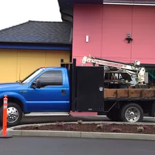 a blue truck parked in front of a pink building related to Ultimate Welding Truck Beds: A Comprehensive Guide