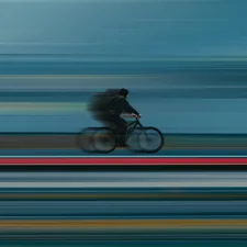 a blurry photo of a person riding a bike related to Speed into Childhood with a Blue Race Car Toddler Bed