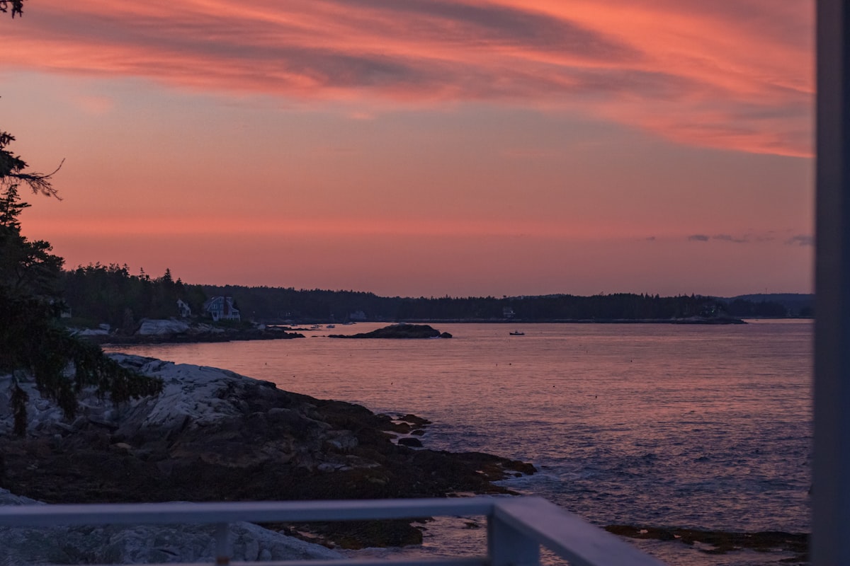 a body of water with a land in the back related to Discover the Charm of Bed and Breakfast Maine