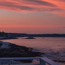 a body of water with a land in the back related to Discover the Charm of Bed and Breakfast Maine