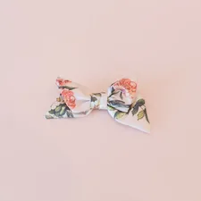 a bow tie with flowers on it on a pink background related to Sweet Dreams with Plum and Bow Bedding