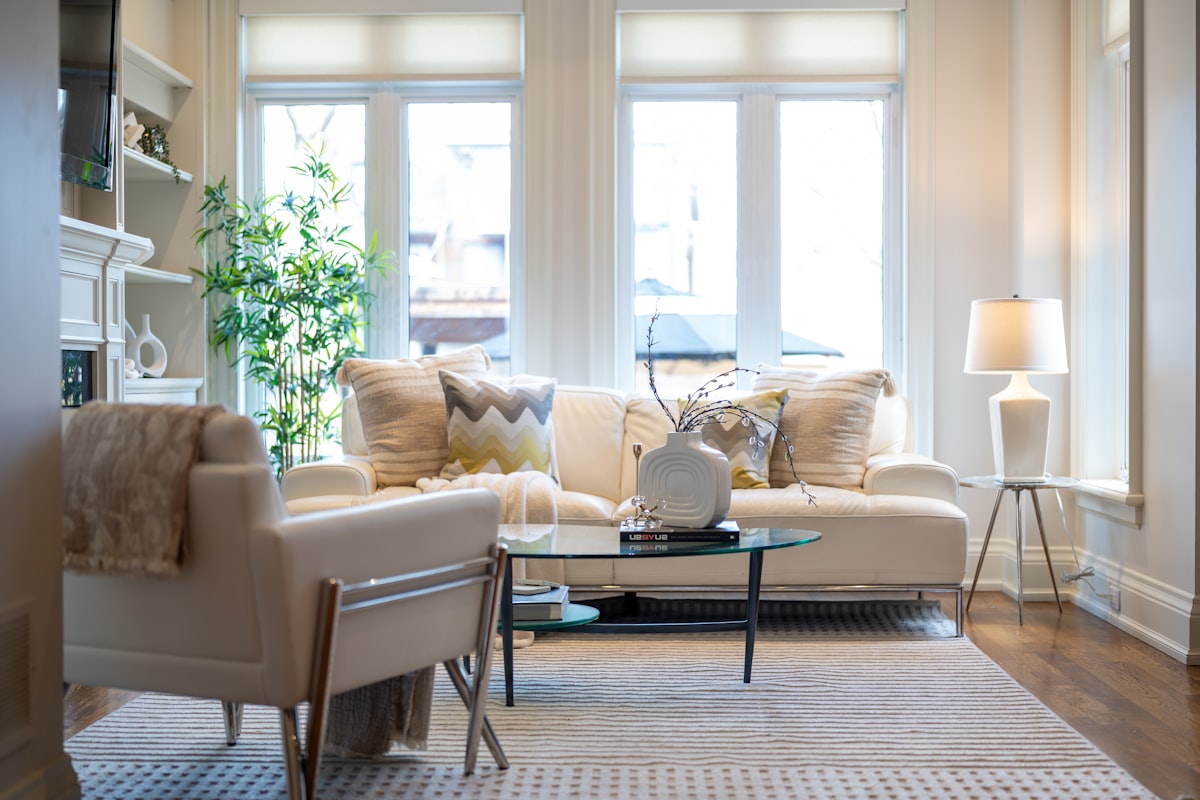 A bright, elegant living room with a sofa and armchair. related to Elevate Your Living Room Style with Tailored Valances