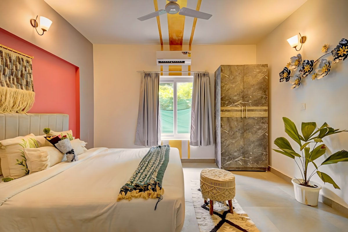 A bright, modern bedroom with a bed, wardrobe, and plant. related to Ultimate Guide to Air Beds for Comfort