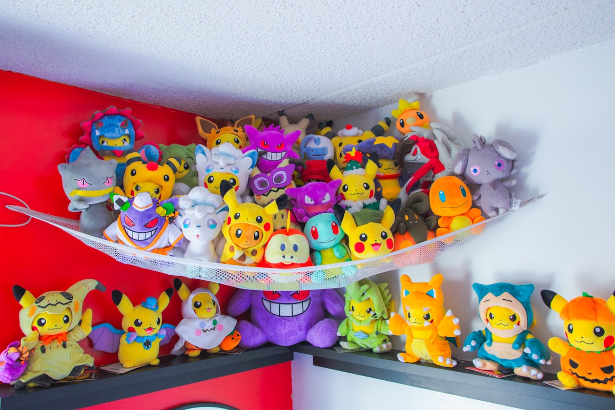 a bunch of stuffed animals are on a shelf related to Catch the Dream: Unleash Your Inner Pokémon Fan with a Queen-Sized Bed Set