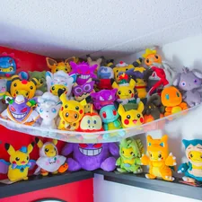 a bunch of stuffed animals are on a shelf related to Catch the Dream: Unleash Your Inner Pokémon Fan with a Queen-Sized Bed Set