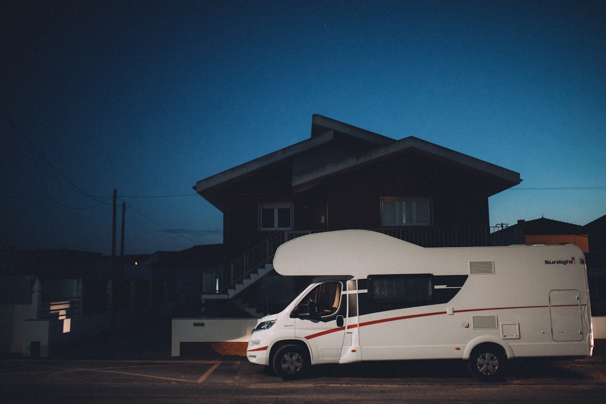 a camper van parked in front of a house at night related to Exploring the Best Motorhomes with Bunk Beds for Family Adventures