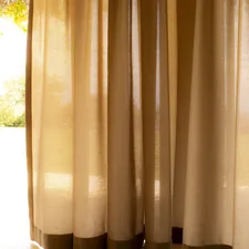 a cat sitting on the floor in front of a window related to Dress Up Your Curtains: The Ultimate Guide to 2.5 Inch Valance Clips