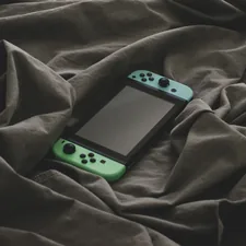 a cell phone on a blanket related to Transform Your Gaming Space: The Ultimate Guide to Gaming Bed Sheets