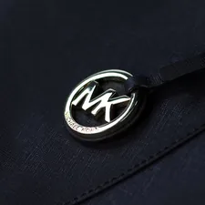 a close up of a badge on a jacket related to Transform Your Bedroom with Michael Kors Bedding