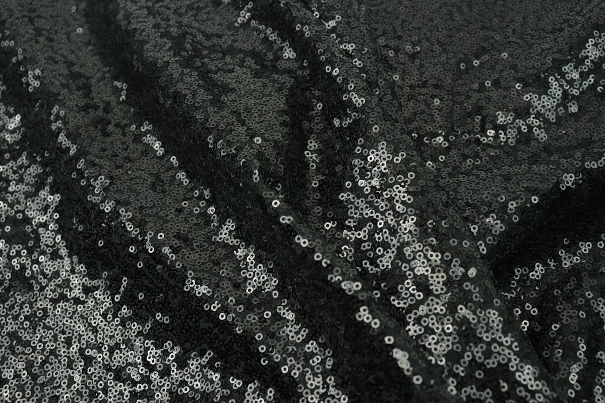a close up of a black and silver sequin fabric related to Black and Silver Valance