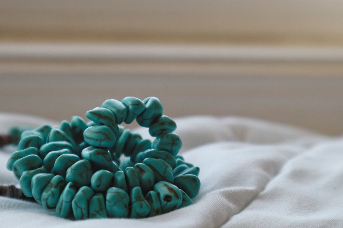a close up of a bunch of beads on a bed related to Transform Your Bedroom with a Stunning Turquoise Bed Set