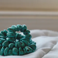 a close up of a bunch of beads on a bed related to Transform Your Bedroom with a Stunning Turquoise Bed Set