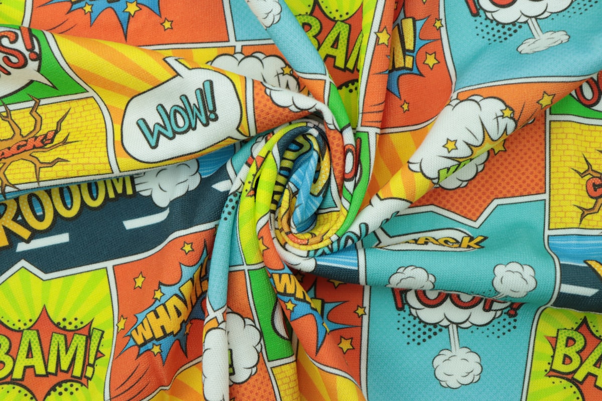 a close up of a colorful fabric with comic characters on it related to Unleash Your Inner Hero with Superhero Full Size Bedding