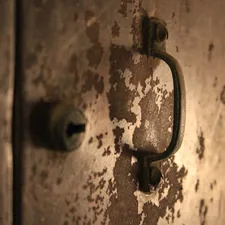 a close up of a door handle related to Industrial Elegance: Reviving Vintage Metal in Modern Sideboards
