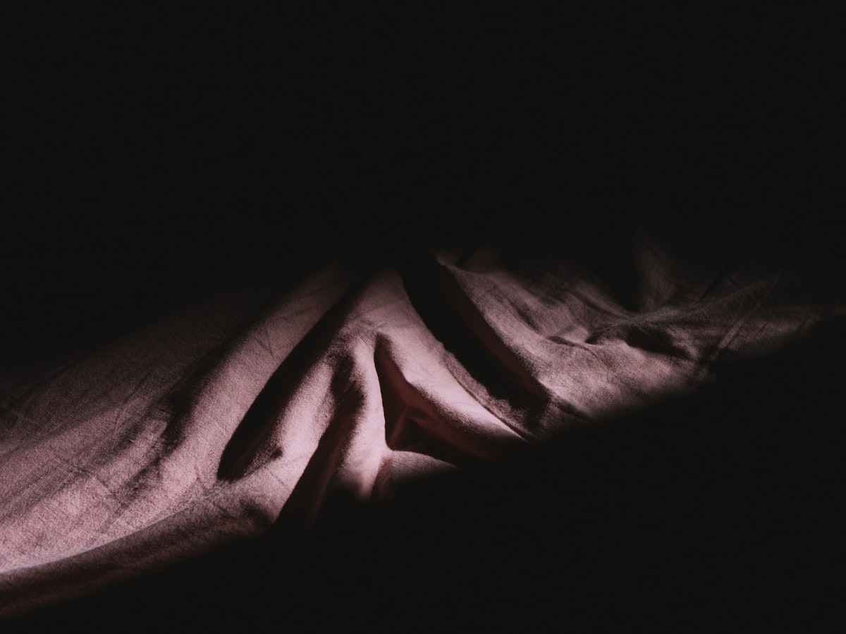 a close-up of a hand related to Stylish Black and Pink Bedding Options