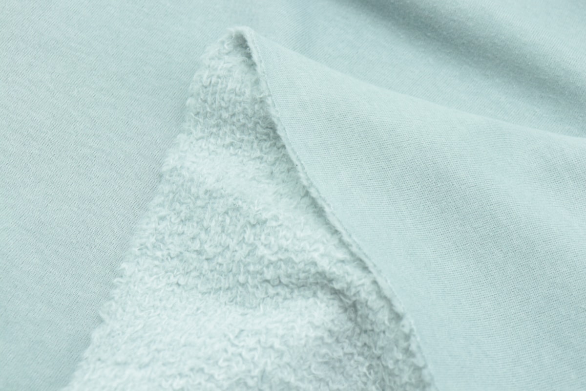 a close up of a light blue fabric related to Soft Comfort with Style: Cotton Coverlets and Quilts