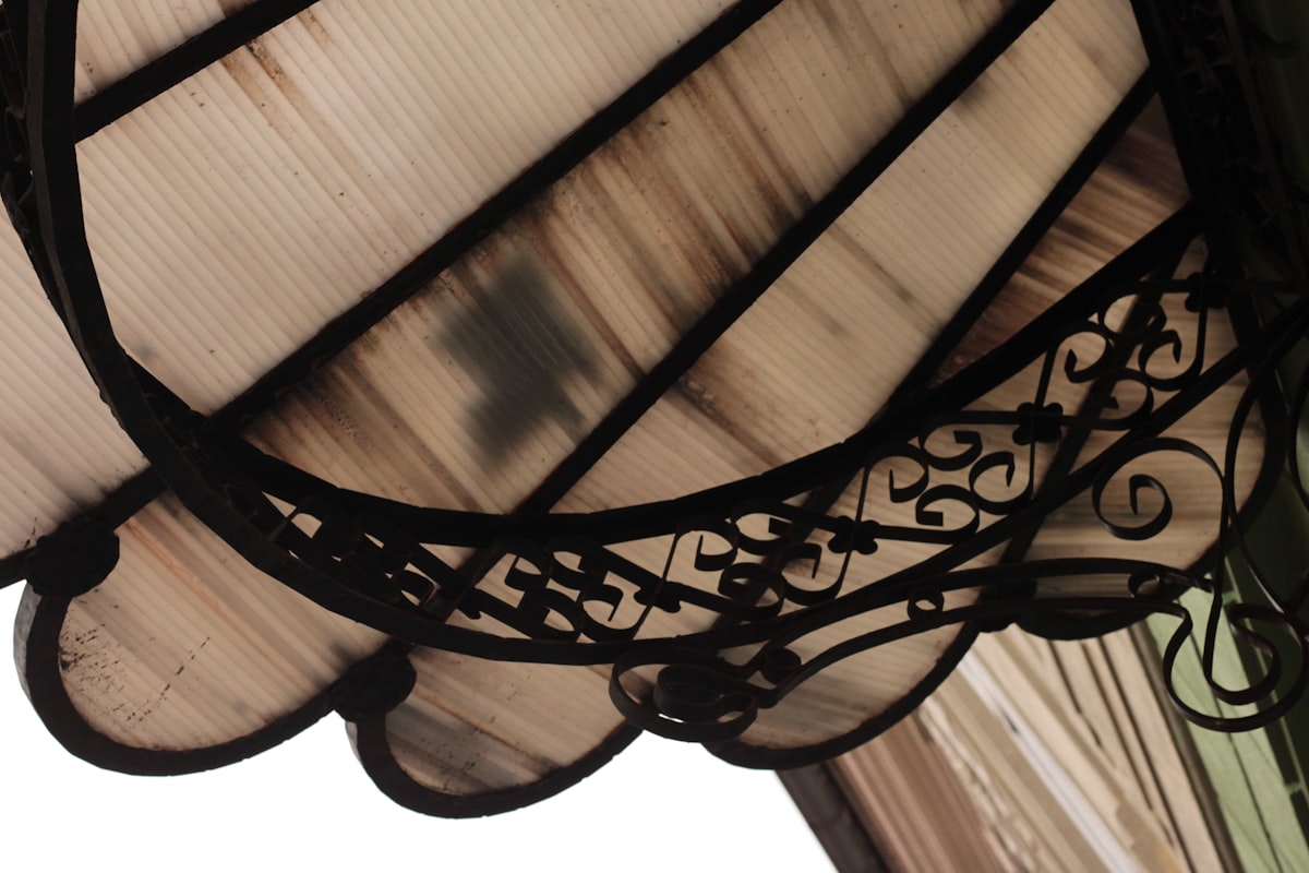 a close up of a light fixture on a building related to Elegant Curved Valance Rods for Your Window Treatments