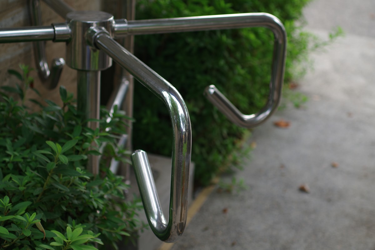A close up of a metal hand rail on a sidewalk related to The Importance of Handicap Bed Rails for Senior Safety