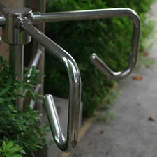 A close up of a metal hand rail on a sidewalk related to The Importance of Handicap Bed Rails for Senior Safety