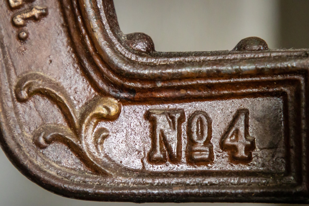 a close up of a metal object with numbers on it related to Cast Iron Chiminea for Sale - One of a Kind Decorative Metal Art