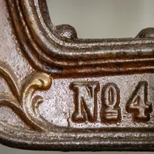 a close up of a metal object with numbers on it related to Cast Iron Chiminea for Sale - One of a Kind Decorative Metal Art