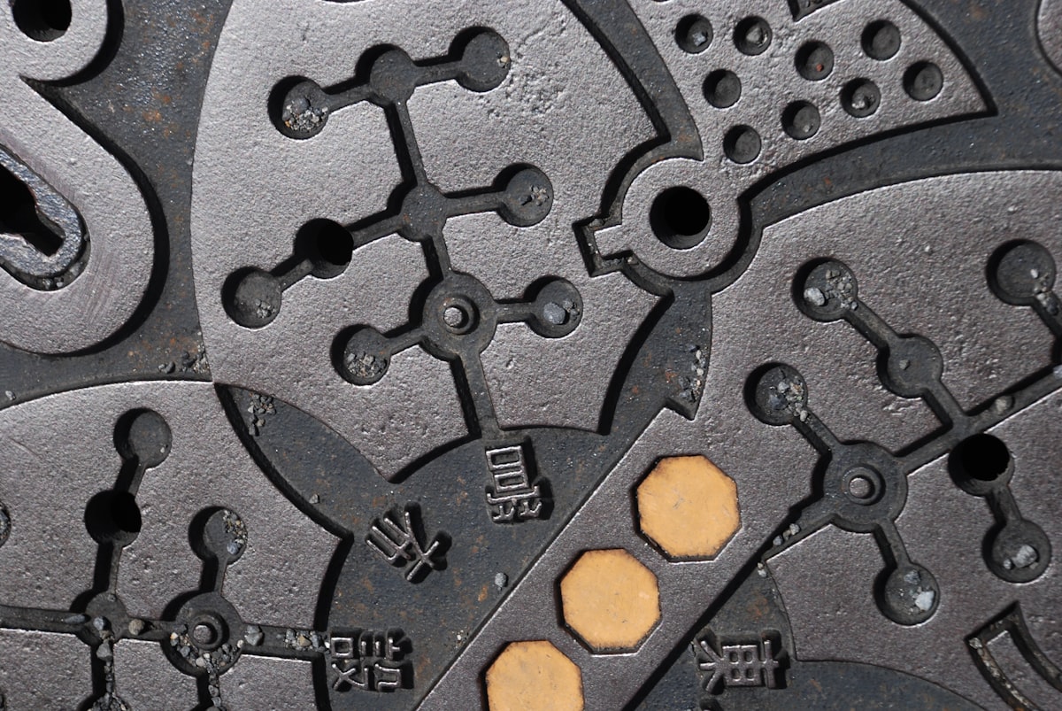 a close up of a metal surface with holes in it related to Mastering the Majestic Cast Iron Chiminea