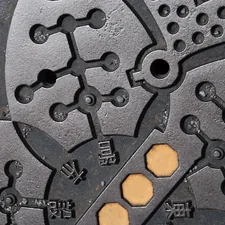 a close up of a metal surface with holes in it related to Mastering the Majestic Cast Iron Chiminea