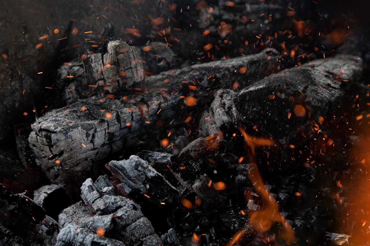a close up of a pile of wood and fire related to The Ultimate Guide to Chiminea Cast Iron: Everything You Need to Know