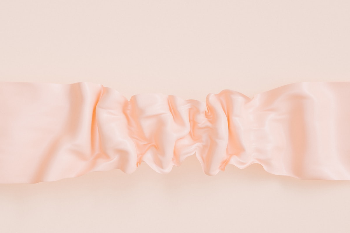 a close up of a pink curtain on a wall related to Warm and welcoming: Pink valance curtains