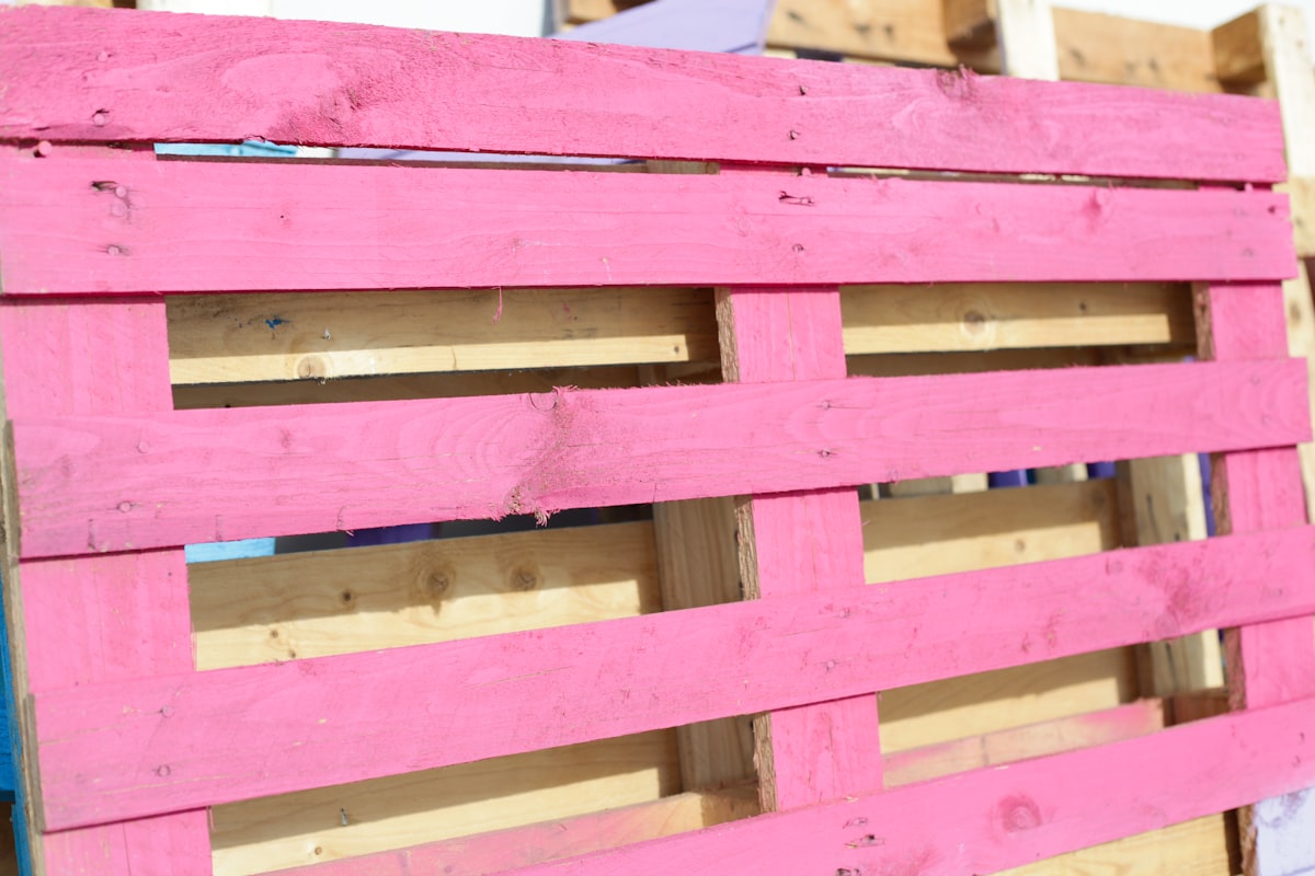 a close up of a pink wooden fence related to How to Make a Pallet Bed: 5 Creative Ideas
