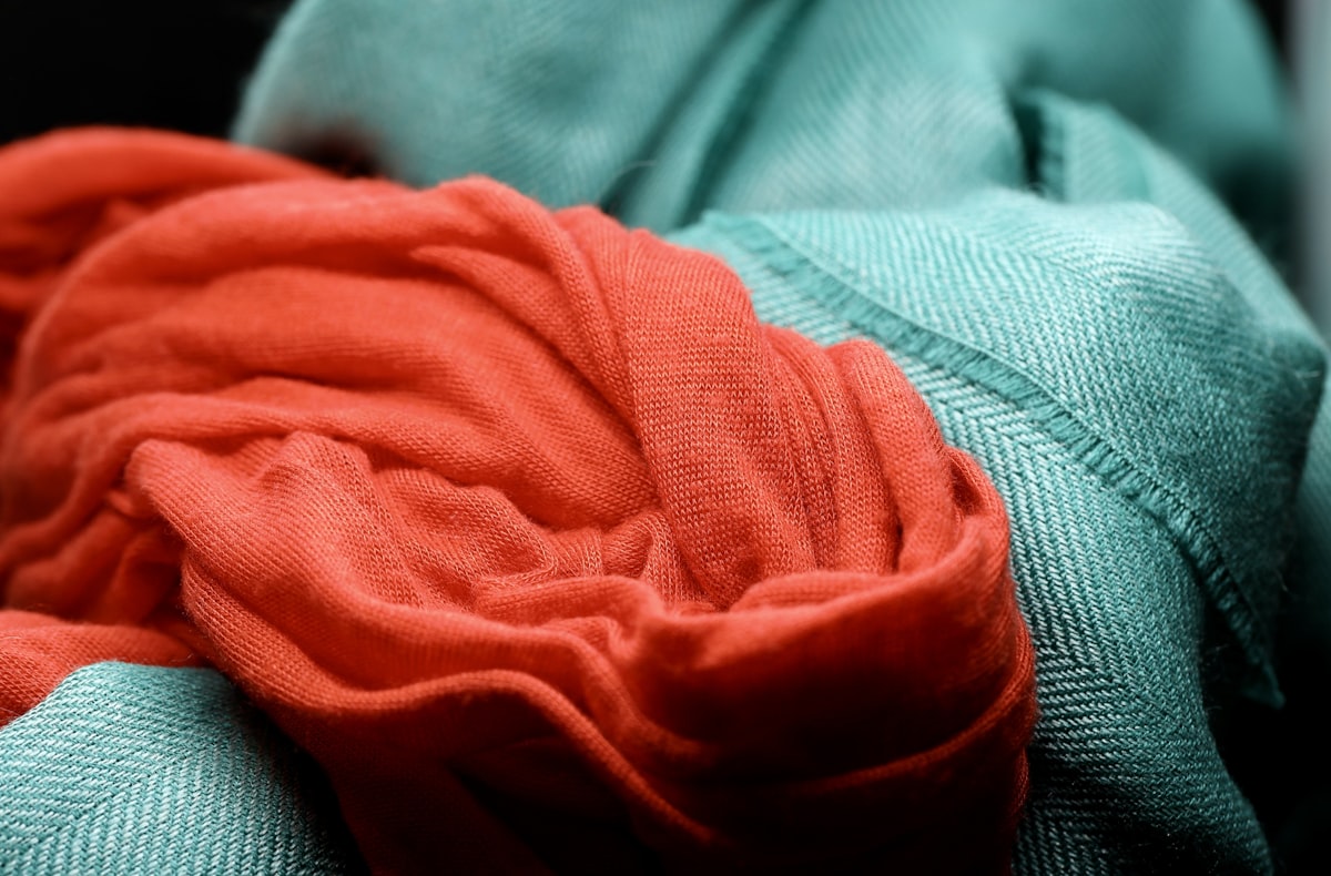 A close up of a red cloth on a chair related to Coral and Teal Bedding: A Refreshing Oasis for Your Bedroom