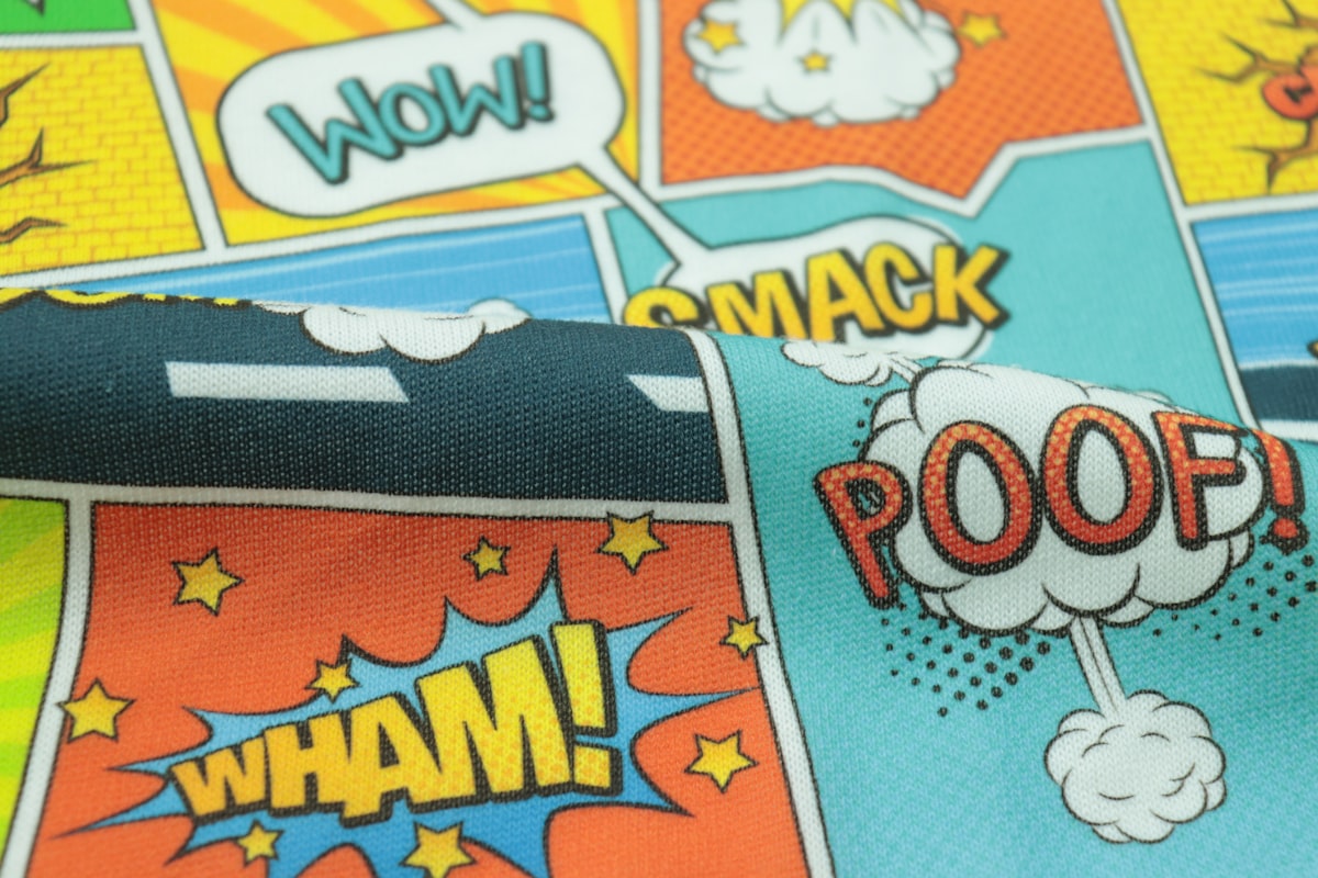 a close up of a tie with comic books on it related to Unleash Her Inner Heroine: The Best Girl Superhero Bedding