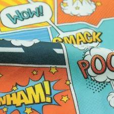 a close up of a tie with comic books on it related to Unleash Her Inner Heroine: The Best Girl Superhero Bedding