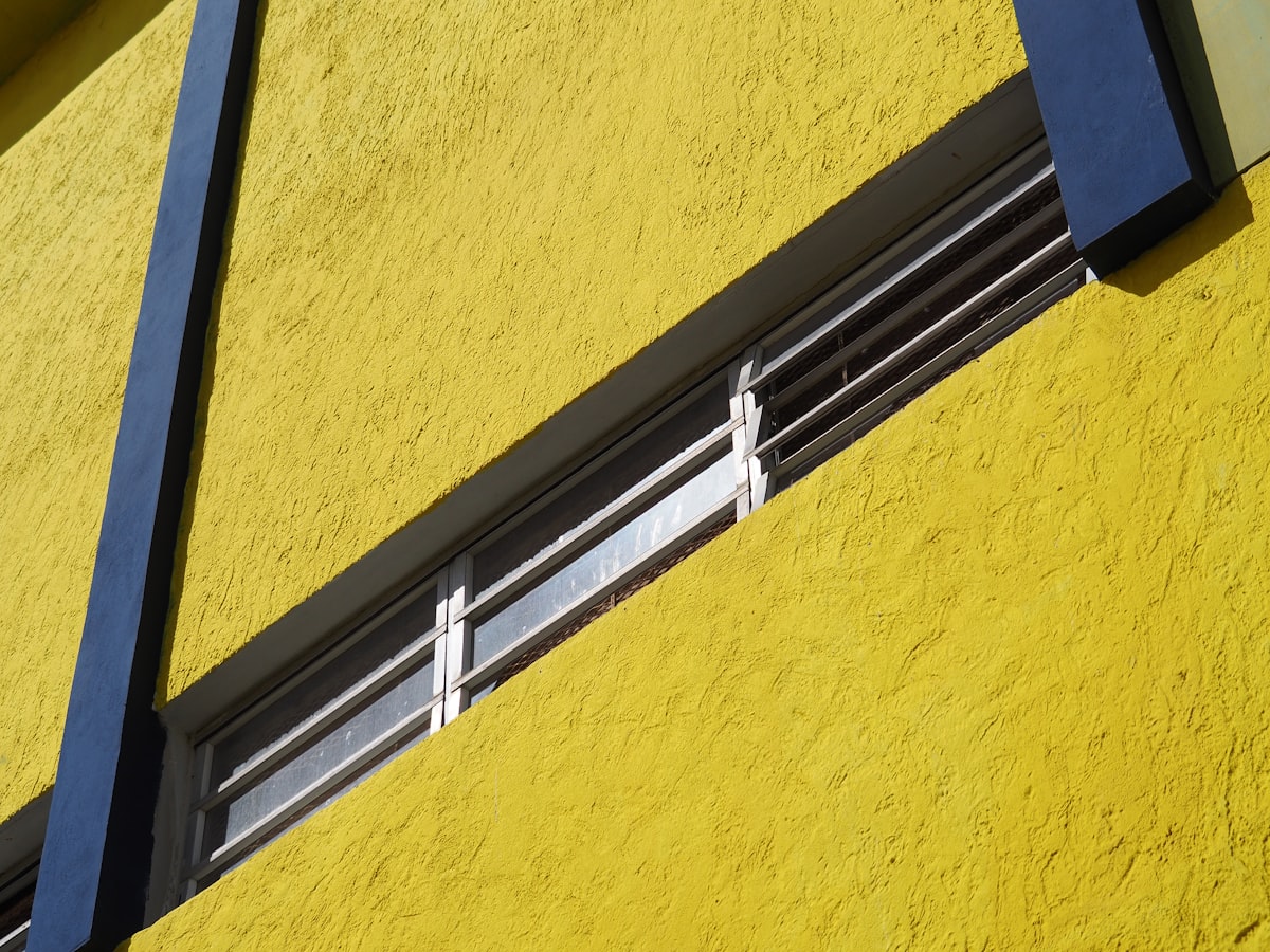 a close up of a window on a yellow building related to A Comprehensive Guide to Window Valance Clips