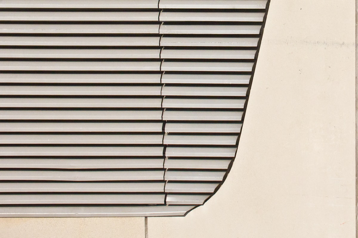 A close up of a window with a bird perched on the window sill related to Light Grey Valance