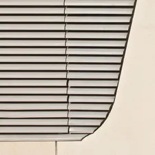 A close up of a window with a bird perched on the window sill related to Light Grey Valance