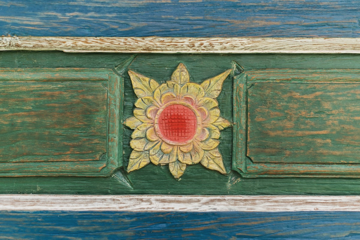 A close up of a wooden door with a flower on it related to Elegance Meets Artistry: Hand Painted Sideboards and Buffets