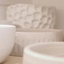 a close up of some white bowls on a table related to Essential Guide to Pots and Pans for Every Kitchen