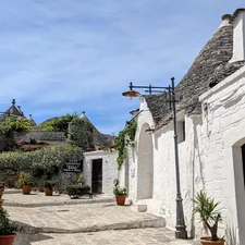 a cobblestone street with potted plants on either side related to Charming Stays in Taos