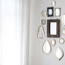 a collection of Moroccan mirrors on a wall related to Elegant Mirror Images: 3 Captivating Mirrored Buffet Sideboard Designs