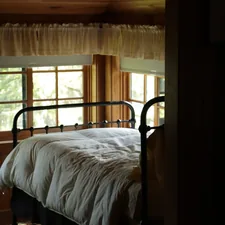 A comfortable bed by the windows. related to The Luxury of Metal Bed Frames: Upgrade Your Queen-Sized Bed