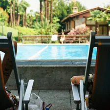A couple of lawn chairs sitting next to a swimming pool related to The Versatility of a Day Bed: Transforming Your Space