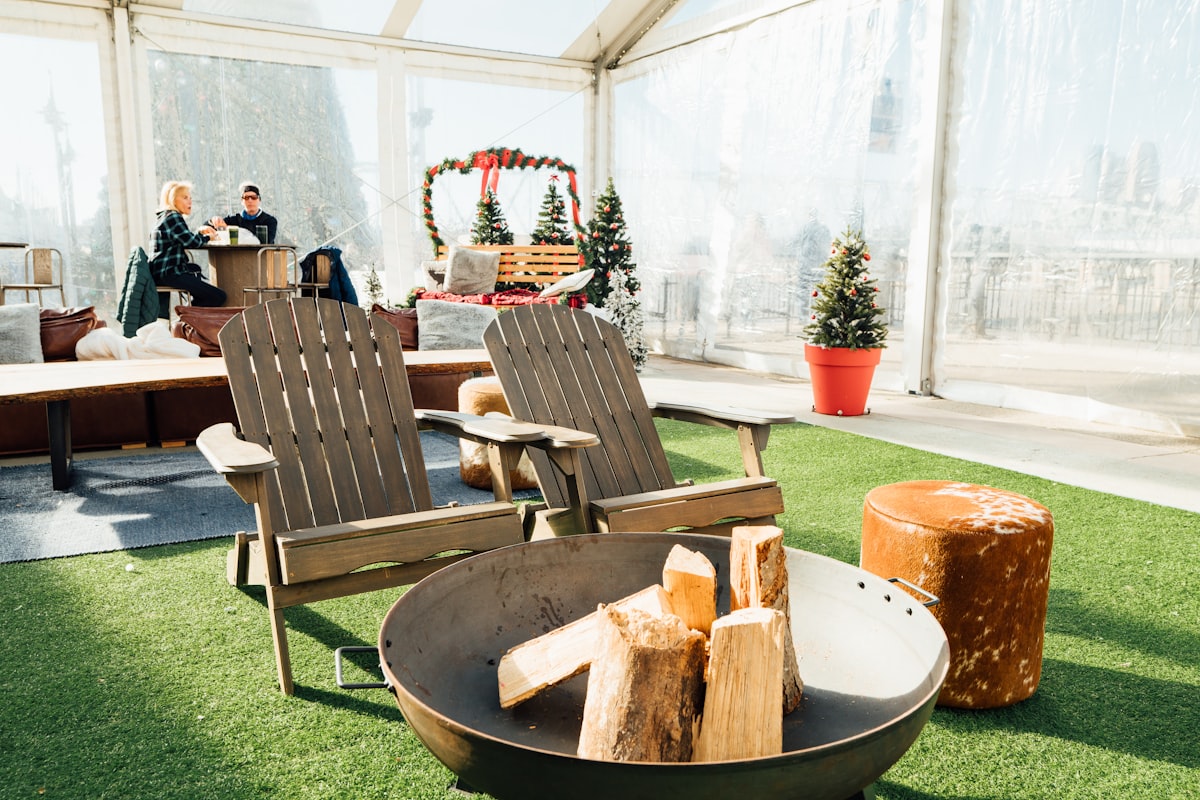 a couple of lawn chairs sitting on top of a lush green field related to Enhancing Your Outdoor Space with the Perfect Fire Pit