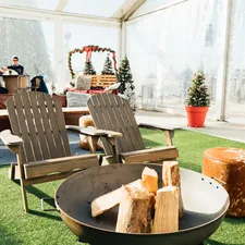 a couple of lawn chairs sitting on top of a lush green field related to Enhancing Your Outdoor Space with the Perfect Fire Pit