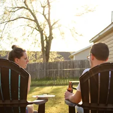 a couple of people sitting in lawn chairs related to Elevate Your Backyard Ambiance with a Chiminea Stand Iron