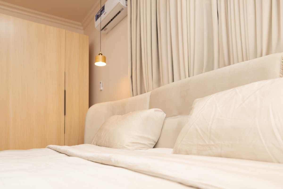 A cozy bedroom with a large bed and light-colored decor. related to Ultimate Guide to Air Beds for Comfort